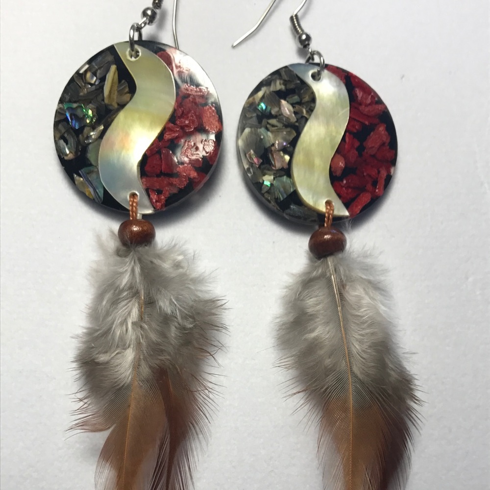 Yin-yang earrings with feathers.